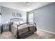Bedroom with gray walls and neutral carpet features a wrought iron bed and bedside table at 6771 Woodcliff Cir, Zionsville, IN 46077