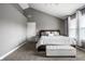 Well-lit bedroom featuring a vaulted ceiling, a comfortable bed, and a view of the windows at 6771 Woodcliff Cir, Zionsville, IN 46077