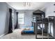 Bedroom with a gray bunk bed featuring a unique house-like frame, carpeting and bright windows at 6771 Woodcliff Cir, Zionsville, IN 46077