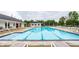 Sparkling community pool with lounge chairs, surrounded by lush greenery, perfect for relaxation and recreation at 6771 Woodcliff Cir, Zionsville, IN 46077