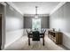 Elegant dining room with a table, chandelier, and carpeted floor, perfect for entertaining at 6771 Woodcliff Cir, Zionsville, IN 46077