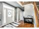 Welcoming home foyer featuring hardwood floors, chandelier, and staircase at 6771 Woodcliff Cir, Zionsville, IN 46077