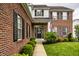 Charming brick home featuring manicured landscaping and wreath on the front door at 6771 Woodcliff Cir, Zionsville, IN 46077