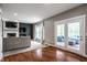 Spacious living room with fireplace, large window, and glass doors to outdoor seating at 6771 Woodcliff Cir, Zionsville, IN 46077