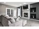 Comfortable living room featuring large sofa, brick fireplace, and large window at 6771 Woodcliff Cir, Zionsville, IN 46077
