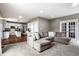 Spacious living room featuring an open layout and view of the kitchen with a large sectional sofa at 6771 Woodcliff Cir, Zionsville, IN 46077