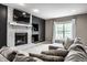 Inviting living room with a cozy fireplace, modern TV setup, and a large window for natural light at 6771 Woodcliff Cir, Zionsville, IN 46077