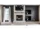 Living room showcasing fireplace with mantle, built-in shelving, and large window at 6771 Woodcliff Cir, Zionsville, IN 46077