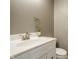 Close up of powder room featuring white vanity with modern fixtures and neutral gray walls at 6771 Woodcliff Cir, Zionsville, IN 46077