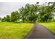Picturesque walking path with mature trees and lush green grass, perfect for a peaceful stroll at 6771 Woodcliff Cir, Zionsville, IN 46077