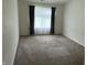 Bedroom with plush carpet and a window for natural light at 6926 Trey Dr, Indianapolis, IN 46113
