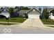 Charming single-story home featuring a well-maintained lawn and an attached two-car garage at 6926 Trey Dr, Indianapolis, IN 46113