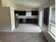 Well-lit kitchen features black cabinets, stainless steel appliances, and a sliding glass door to the outside at 6926 Trey Dr, Indianapolis, IN 46113