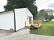 Home exterior featuring a small back deck area with new wood and potted flowers at 712 W Main St, Thorntown, IN 46071