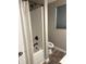 Bathroom featuring a tub shower, neutral walls, wood look floor and a window for light at 712 W Main St, Thorntown, IN 46071