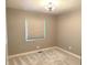 Bedroom featuring plush carpet flooring, neutral walls, and a modern ceiling light fixture at 712 W Main St, Thorntown, IN 46071