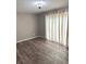 Living room featuring a window with curtains and wood-look flooring at 712 W Main St, Thorntown, IN 46071