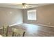 Bright living room featuring neutral walls, updated flooring, and a ceiling fan with overhead lighting at 712 W Main St, Thorntown, IN 46071