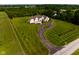 Gorgeous home surrounded by manicured lawn, mature trees, and an inviting circular driveway at 7493 W Lane Rd, McCordsville, IN 46055