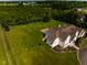 A beautiful home with a sprawling green yard, set against a wooded backdrop at 7493 W Lane Rd, McCordsville, IN 46055
