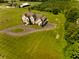 Expansive property showcasing a stately home, barn, and lush green acreage in a serene setting at 7493 W Lane Rd, McCordsville, IN 46055