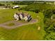 Picturesque aerial view featuring a charming home, surrounded by a sprawling green lawn and mature trees at 7493 W Lane Rd, McCordsville, IN 46055