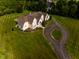 Picturesque aerial view featuring a charming home, surrounded by a sprawling green lawn and mature trees at 7493 W Lane Rd, McCordsville, IN 46055
