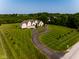 Elegant home with circular drive and striped lawn, showcasing luxury living at 7493 W Lane Rd, McCordsville, IN 46055