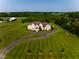 Expansive aerial view of the property showcasing the home, driveway, and lush green surroundings at 7493 W Lane Rd, McCordsville, IN 46055