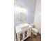 Stylish powder room featuring a modern vanity with gold accents and distinctive wallpaper at 7493 W Lane Rd, McCordsville, IN 46055