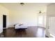 Spacious bedroom with dark hardwood floors, a ceiling fan, and a door leading to the backyard at 7493 W Lane Rd, McCordsville, IN 46055