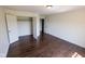Bedroom with laminate floors, neutral walls, a closet, and a door at 7493 W Lane Rd, McCordsville, IN 46055
