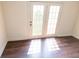 Bedroom featuring laminate floors and French doors with view at 7493 W Lane Rd, McCordsville, IN 46055