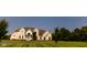 Impressive two-story brick home with manicured lawn and circular driveway, surrounded by mature trees, exudes timeless elegance at 7493 W Lane Rd, McCordsville, IN 46055