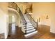 Open-concept foyer featuring a staircase with iron railings and abundant natural light at 7493 W Lane Rd, McCordsville, IN 46055