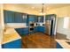 Spacious kitchen with bright blue cabinets, stainless steel appliances, and marble countertops at 7493 W Lane Rd, McCordsville, IN 46055