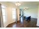 Bright living room featuring hardwood floors, modern lighting, and a decorative fireplace at 7493 W Lane Rd, McCordsville, IN 46055