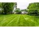 Expansive backyard showcasing lush greenery and a well-maintained lawn at 7743 Camelback Dr, Indianapolis, IN 46250