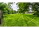 Large, meticulously maintained backyard lawn, perfect for outdoor activities at 7743 Camelback Dr, Indianapolis, IN 46250