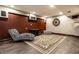 Finished basement rec room with zebra chair and patterned area rug at 7743 Camelback Dr, Indianapolis, IN 46250