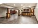 Finished basement features a bar, columns and wood look vinyl floors at 7743 Camelback Dr, Indianapolis, IN 46250