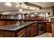 Basement bar with granite countertops, a sink, and stainless steel appliances at 7743 Camelback Dr, Indianapolis, IN 46250