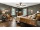 Comfortable bedroom with hardwood floors, sitting chair, and natural light at 7743 Camelback Dr, Indianapolis, IN 46250