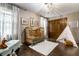 Bedroom featuring a wooden crib, teepee, soft rug, and plenty of natural light, creating a warm, inviting atmosphere at 7743 Camelback Dr, Indianapolis, IN 46250
