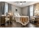Cozy bedroom with a decorative headboard, vintage vanity, ceiling fan, neutral color scheme, and natural light at 7743 Camelback Dr, Indianapolis, IN 46250