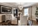 Elegantly appointed dining space with chandelier, buffet table, and an area rug over hardwood flooring at 7743 Camelback Dr, Indianapolis, IN 46250