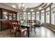 Elegant dining room featuring a large window, chandelier lighting, and stylish dining table with six chairs at 7743 Camelback Dr, Indianapolis, IN 46250