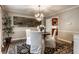 Formal dining room showcasing a chandelier, artwork, and an area rug over hardwood flooring at 7743 Camelback Dr, Indianapolis, IN 46250