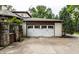 Detached two-car garage with carriage doors and well-maintained driveway at 7743 Camelback Dr, Indianapolis, IN 46250