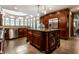 Spacious kitchen boasts stainless appliances, dark wood cabinetry, granite counters, and a large island at 7743 Camelback Dr, Indianapolis, IN 46250